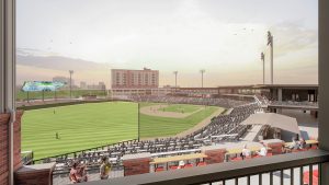 Apartments For Rent Downtown Knoxville View of a baseball stadium with a field, seating, and a scoreboard. People are sitting in the stands, and buildings are visible in the background under a cloudy sky. Knoxville Apartments